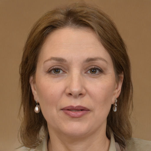 Joyful white adult female with medium  brown hair and brown eyes