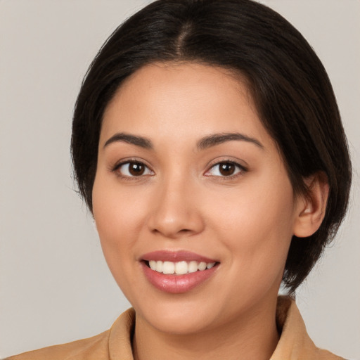 Joyful white young-adult female with medium  brown hair and brown eyes