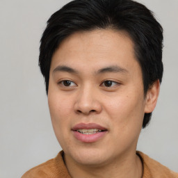 Joyful asian young-adult male with short  brown hair and brown eyes