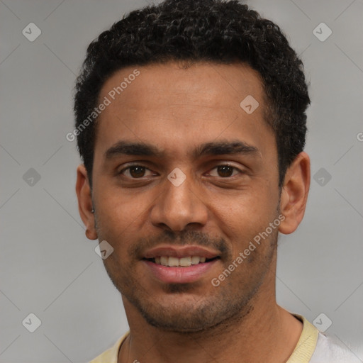 Joyful black young-adult male with short  black hair and brown eyes