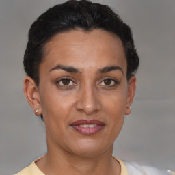 Joyful latino young-adult female with short  black hair and brown eyes