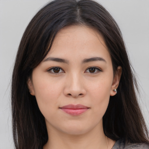 Joyful asian young-adult female with long  brown hair and brown eyes