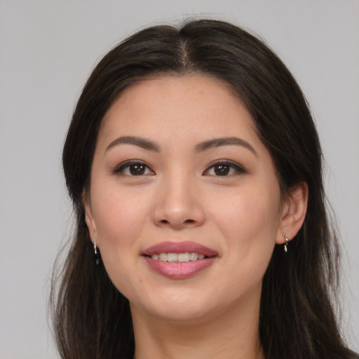 Joyful asian young-adult female with long  brown hair and brown eyes