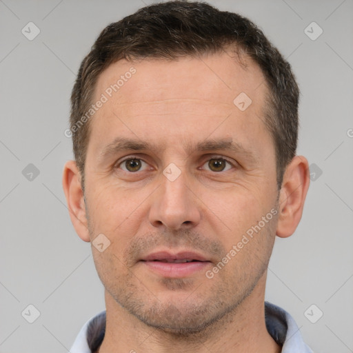 Joyful white adult male with short  brown hair and brown eyes