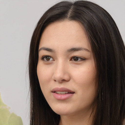 Joyful asian young-adult female with long  brown hair and brown eyes