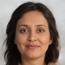 Joyful white adult female with long  brown hair and brown eyes