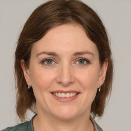 Joyful white adult female with medium  brown hair and grey eyes