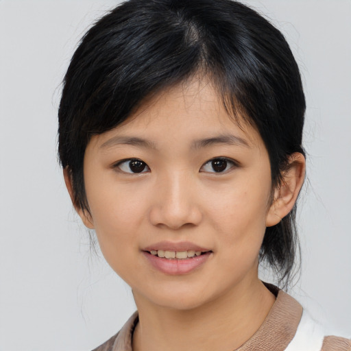Joyful asian young-adult female with medium  black hair and brown eyes