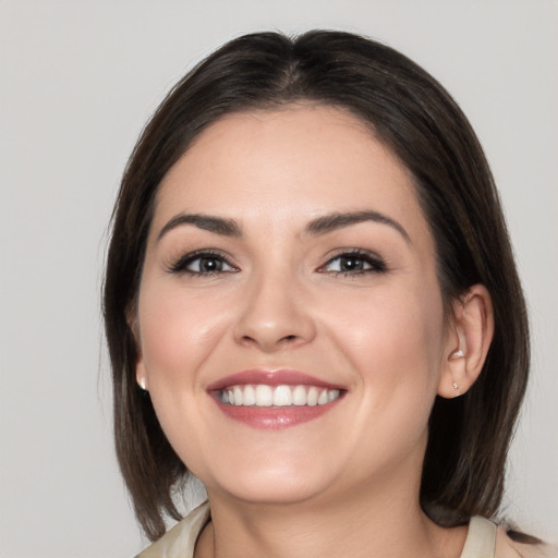 Joyful white young-adult female with medium  brown hair and brown eyes