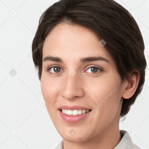 Joyful white young-adult female with short  brown hair and grey eyes