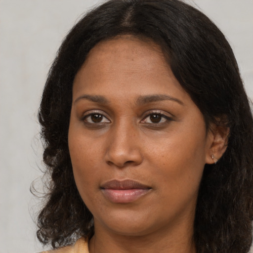 Joyful black young-adult female with medium  brown hair and brown eyes