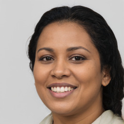 Joyful latino young-adult female with medium  brown hair and brown eyes