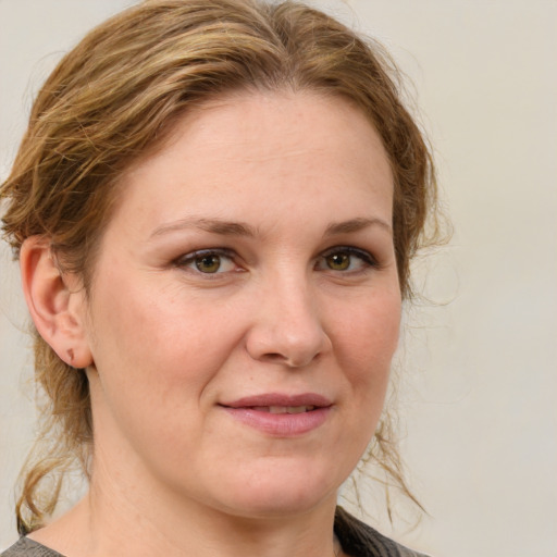 Joyful white adult female with medium  brown hair and blue eyes