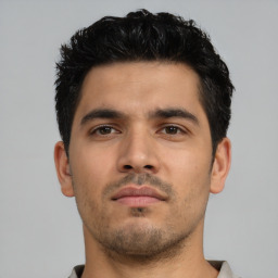 Neutral latino young-adult male with short  black hair and brown eyes