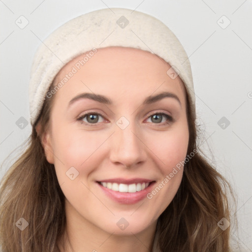 Joyful white young-adult female with long  brown hair and blue eyes