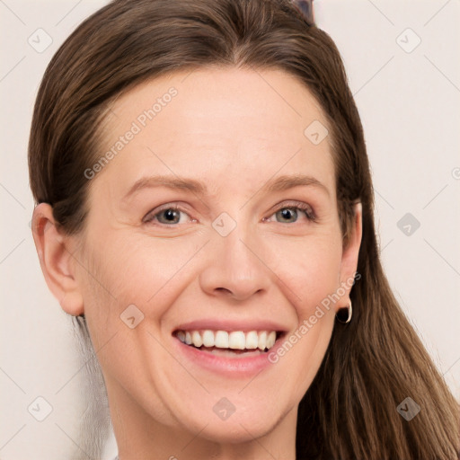 Joyful white adult female with long  brown hair and grey eyes