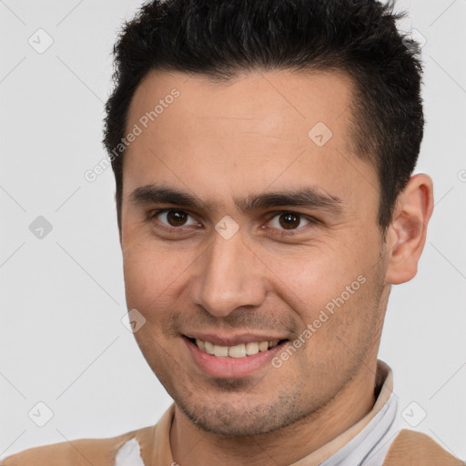 Joyful white young-adult male with short  brown hair and brown eyes