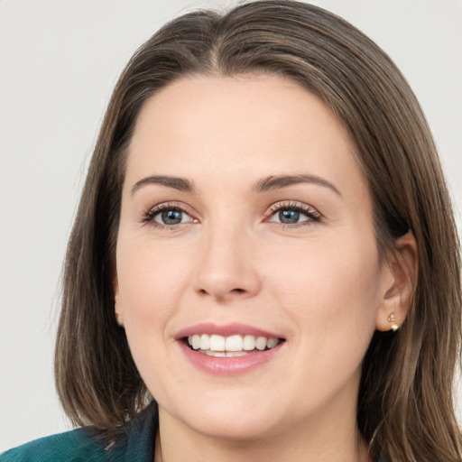 Joyful white young-adult female with medium  brown hair and grey eyes