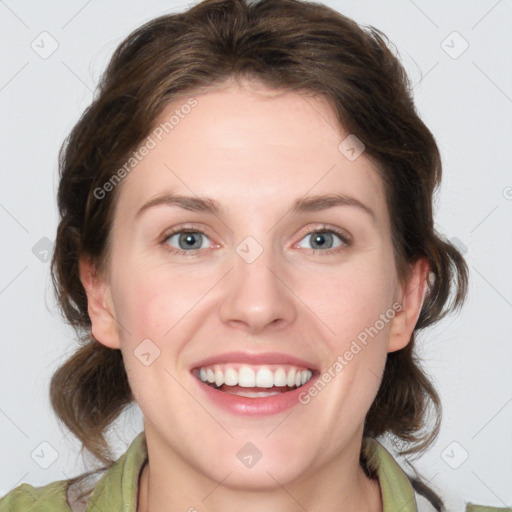 Joyful white young-adult female with medium  brown hair and green eyes