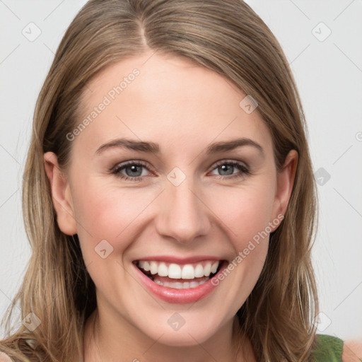 Joyful white young-adult female with long  brown hair and grey eyes