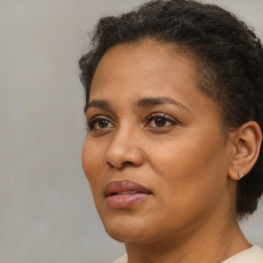 Joyful black adult female with short  brown hair and brown eyes