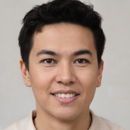 Joyful latino young-adult male with short  brown hair and brown eyes