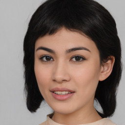 Joyful asian young-adult female with medium  black hair and brown eyes