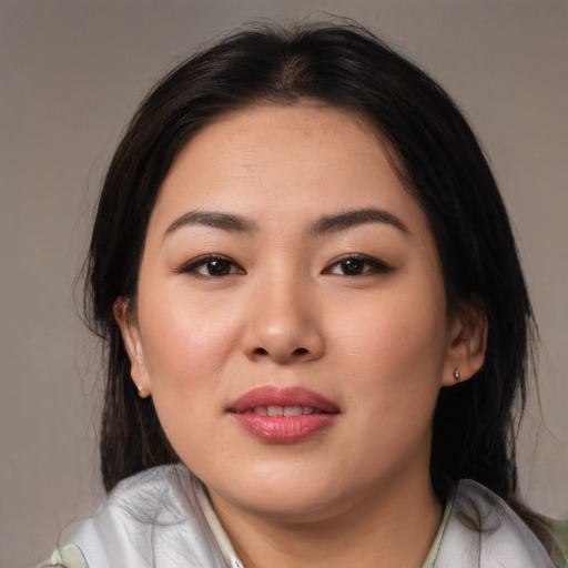 Joyful asian young-adult female with medium  black hair and brown eyes