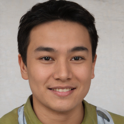 Joyful asian young-adult male with short  brown hair and brown eyes