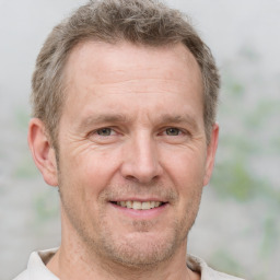 Joyful white adult male with short  brown hair and grey eyes