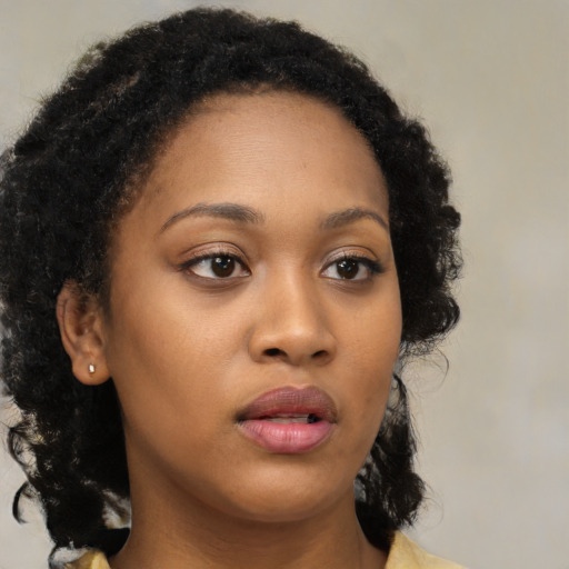 Neutral black young-adult female with long  brown hair and brown eyes