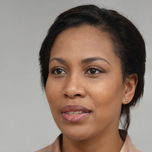 Joyful black young-adult female with medium  brown hair and brown eyes