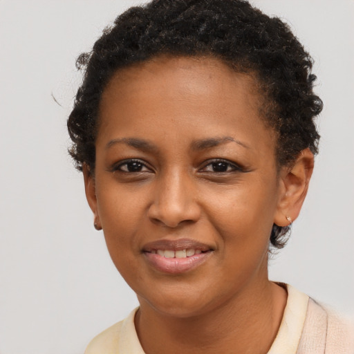 Joyful black young-adult female with short  brown hair and brown eyes