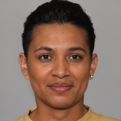 Joyful latino young-adult female with short  black hair and brown eyes