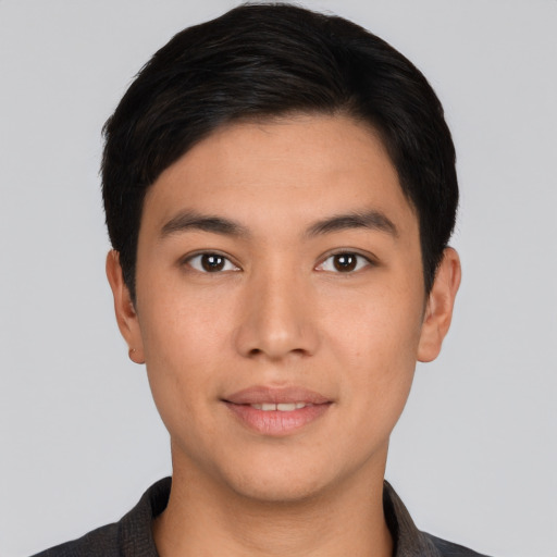 Joyful latino young-adult male with short  brown hair and brown eyes