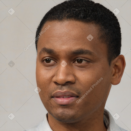 Joyful black young-adult male with short  black hair and brown eyes