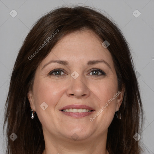 Joyful white adult female with long  brown hair and brown eyes