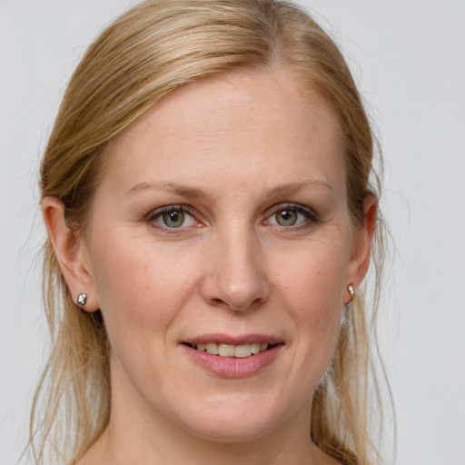 Joyful white young-adult female with medium  brown hair and blue eyes