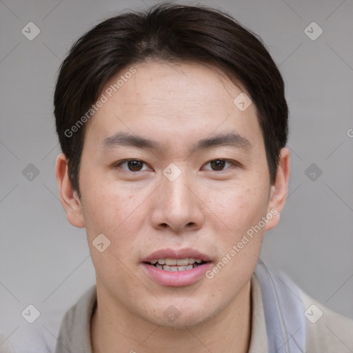 Joyful asian young-adult male with short  brown hair and brown eyes