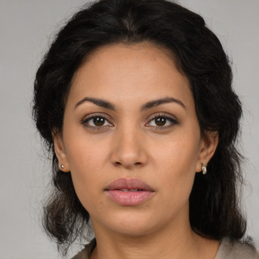 Neutral latino young-adult female with medium  brown hair and brown eyes