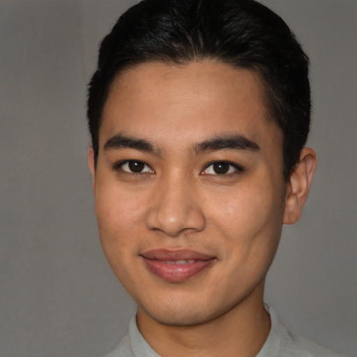 Joyful latino young-adult male with short  brown hair and brown eyes