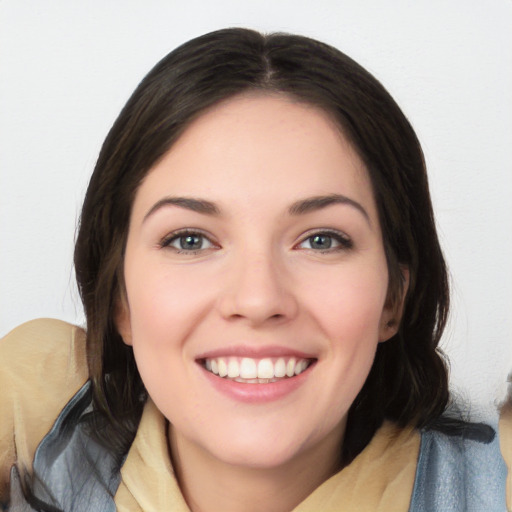 Joyful white young-adult female with medium  black hair and brown eyes