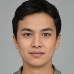 Joyful asian young-adult male with short  black hair and brown eyes