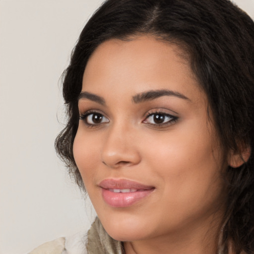 Joyful latino young-adult female with long  brown hair and brown eyes