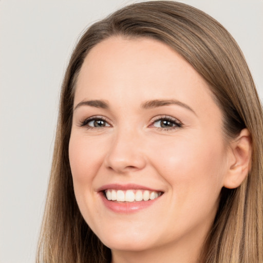 Joyful white young-adult female with long  brown hair and brown eyes