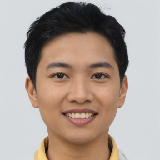 Joyful asian young-adult male with short  black hair and brown eyes