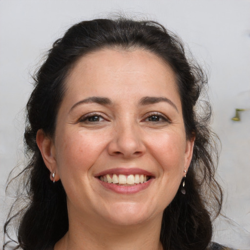 Joyful white adult female with long  brown hair and brown eyes