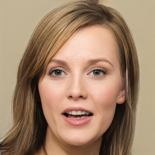 Joyful white young-adult female with long  brown hair and grey eyes