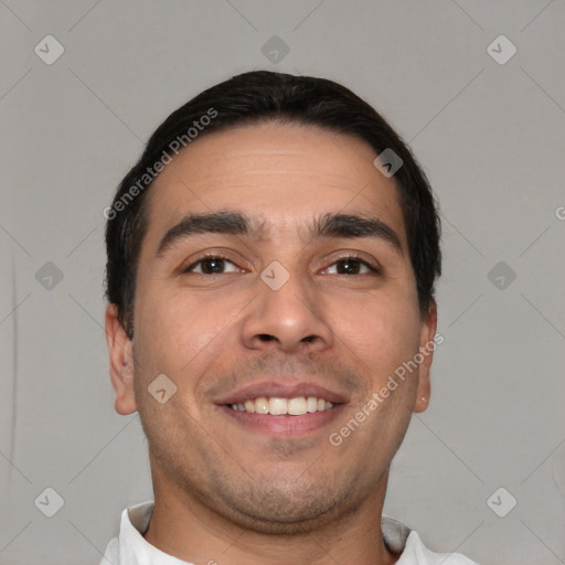 Joyful white young-adult male with short  black hair and brown eyes