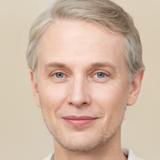 Joyful white adult male with short  brown hair and grey eyes